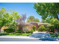 Beautiful single story home with well manicured yard and mature trees and landscaping at 63 Feather Sound Dr, Henderson, NV 89052