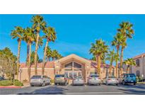 Community clubhouse with palm trees, parking, and desert landscaping at 700 Carnegie St # 4113, Henderson, NV 89052