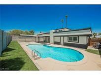 Backyard view featuring a refreshing swimming pool and lush lawn, perfect for outdoor enjoyment at 716 Vincent Way, Las Vegas, NV 89145