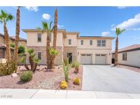 Modern two-story home featuring a stone facade, a two-car garage, and desert landscaping with palm trees at 8824 Killians Greens Dr, Las Vegas, NV 89131