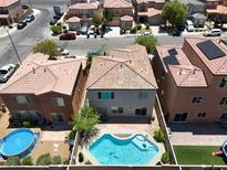 Aerial view of a backyard with a pool and neighboring homes at 9074 Iron Cactus Ave, Las Vegas, NV 89148