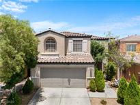 Charming two-story home featuring a two-car garage and beautiful desert landscaping at 9074 Iron Cactus Ave, Las Vegas, NV 89148