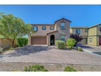 Charming two-story home featuring a desert landscape and a spacious driveway at 9542 Ridgeglen Ct, Las Vegas, NV 89148