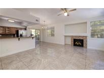 Bright open living room with tile floors, fireplace, and sliding door to the patio at 1705 King James St # 203, Las Vegas, NV 89144
