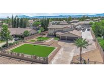 Stunning two-story home featuring an expansive driveway, a manicured lawn, and mature landscaping at 1919 Belcastro St, Las Vegas, NV 89117