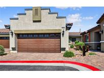 Charming home with a brown garage door and a beautifully landscaped yard at 2175 Limestone Cove Ct, Laughlin, NV 89029