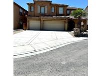 Two-story home with large three car garage, desert landscaping, and beautiful architecture at 3221 Villa Pisani Ct, North Las Vegas, NV 89031