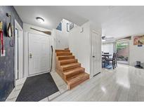 Inviting entryway with hardwood stairs, neutral paint, and a glimpse of the dining area at 3363 Pavlo St, Las Vegas, NV 89121