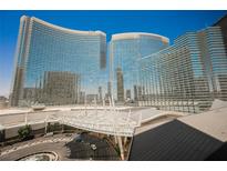 Striking view of a high-rise building featuring unique architecture and a sleek, modern design against a bright blue sky at 3726 Las Vegas Blvd # 704, Las Vegas, NV 89158