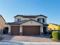 Charming two-story home with a three-car garage and a meticulously brick paved driveway at 4076 Topaz Hills Dr, North Las Vegas, NV 89032