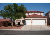 Two-story home with a red tile roof and a two-car garage, shaded by a mature tree at 4126 Jessica Marie St, North Las Vegas, NV 89032