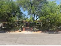 Charming single-story home featuring lush landscaping, classic architecture, and inviting curb appeal at 4444 Denia Cir, Las Vegas, NV 89108