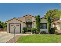 Charming single-story home with well-manicured lawn, mature trees, and a two-car garage at 5401 Broadwater Ln, Las Vegas, NV 89130