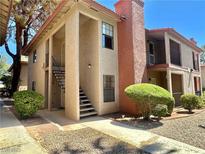 Two-story exterior showcasing neutral stucco, terracotta accents, and mature landscaping with a community feel at 5576 W Rochelle Ave # 27A, Las Vegas, NV 89103
