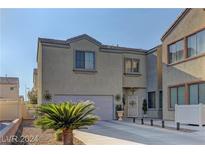 Inviting two-story home featuring a two-car garage, tidy landscaping, and charming front entrance at 6329 Kitamaya St, North Las Vegas, NV 89031