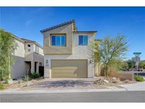 Modern two-story home with a two-car garage, desert landscaping, and a brick driveway on a sunny day at 7853 Bethel Heights Ln, Las Vegas, NV 89113