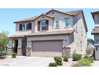 Two-story home featuring a desert landscaped yard, a two-car garage, and a classic red-tile roof at 8186 Guadiano Ave, Las Vegas, NV 89113