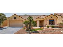 Charming single story home with a desert landscape, a two-car garage, and a red tile roof at 9717 Buckhorn Dr, Las Vegas, NV 89134