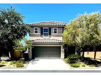 Charming two-story home with a tile roof, a spacious garage, and a well-maintained landscaped front yard at , Las Vegas, NV 89141