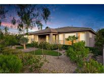 Charming single-story home boasting mature landscaping, desert rock, and a meticulously maintained front yard at 10400 Premia Pl, Las Vegas, NV 89135