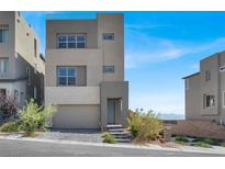 Modern two-story home with clean lines, large windows, neutral color palette, and manicured landscaping at 11658 Midnight Melody Ave, Las Vegas, NV 89138