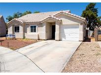 Charming single story home featuring a tile roof, two car garage and well manicured landscaping at 1709 High Breeze Ct, Las Vegas, NV 89106