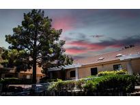 Charming condo featuring a red tile roof, mature trees, and a meticulously landscaped front yard at 2851 S Valley View Blvd # 1130, Las Vegas, NV 89102