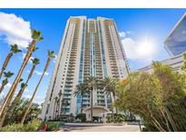 High-rise exterior view with tall palm trees and a bright blue sky in the background at 2877 Paradise Rd # 702, Las Vegas, NV 89109
