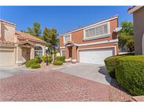 Charming two-story townhome with a tile roof, well-maintained landscaping, and an attached two-car garage at 3221 Epson St, Las Vegas, NV 89129