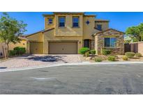 Charming two-story home with a well-manicured lawn, three car garage, and stylish stone accents at 397 Pearl Fountains Ct, Las Vegas, NV 89148