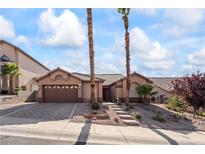 Charming single-story home with desert landscaping, neutral tones, and a two-car garage at 517 Chance Cove Dr, Henderson, NV 89052