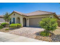 Inviting single-story home with a tile roof, arched entry, and desert landscaping at 7224 Piute Mesa St, North Las Vegas, NV 89084