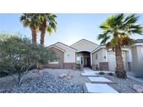Inviting single-story home with desert landscaping and majestic palm trees in a sunny setting at 821 Star Pine Dr, Las Vegas, NV 89144