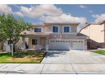 Inviting two-story home features a three-car garage, manicured lawn, and desert landscaping at 9709 Casper Peak Ct, Las Vegas, NV 89117