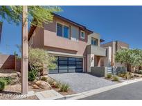 Beautiful two-story home with modern architecture and glass garage door at 10342 Kesington Dr, Las Vegas, NV 89135