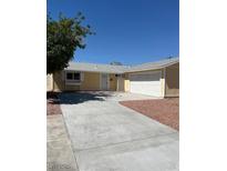 Cozy single-story home featuring an attached two-car garage, neutral paint and low maintenance landscaping at 1809 Lamplighter Ln, Las Vegas, NV 89104