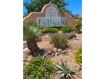 La Posada community entrance sign featuring lush landscaping with desert plants and decorative stones on a sunny day at 1908 Rio Canyon Ct # 105, Las Vegas, NV 89128