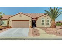Charming single-story home with a well-manicured front yard and a spacious two-car garage at 2217 Merrimack Valley Ave, Henderson, NV 89044