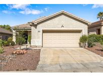 Charming single-story home featuring a two-car garage and low maintenance desert landscaping at 3257 Rushing Waters Pl, Las Vegas, NV 89135