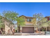 Charming two-story home featuring a two-car garage and desert landscaping in front at 2300 Sky Island Dr, Henderson, NV 89002