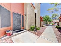 Inviting front door with security screen and well-maintained landscaping leading to the home at 2352 Pickwick Dr # 85, Henderson, NV 89014