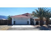 Charming single-story home with a well-maintained front yard and a two-car garage at 2801 Peggy Ave, Pahrump, NV 89048