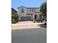 Charming two-story home with a tile roof, arched entry, and a two-car garage at 600 Our Heritage St, Henderson, NV 89011