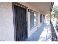 Apartment front door with security gate and covered walkway at 605 S Royal Crest Cir # 8, Las Vegas, NV 89169