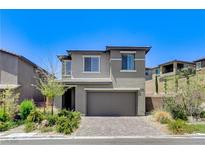 Charming two-story home with a well-manicured lawn and a two-car garage at 689 Rogue Wave St, Las Vegas, NV 89138