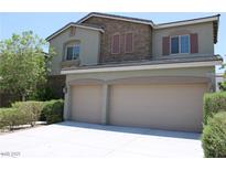 Charming two-story home featuring a two-car garage and stone accents on the upper level at 9065 Mastodon Ave, Las Vegas, NV 89149