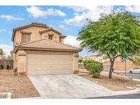 Charming two-story home with a large garage and landscaped front yard, tile roof, and beautiful mature landscaping at 9626 Grapeland Ave, Las Vegas, NV 89148