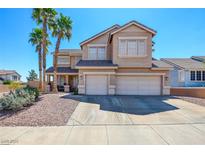 Inviting two-story home with three-car garage, manicured landscaping, and desert-friendly rock groundcover at 98 Milicity Rd, Henderson, NV 89012