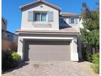 Charming two-story home with a well-maintained front yard and a two-car garage in a quiet neighborhood at 10449 Forked Run St, Las Vegas, NV 89178