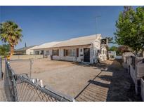 Charming single-story home with a quaint front yard and classic architectural details at 1213 New Mexico St, Boulder City, NV 89005